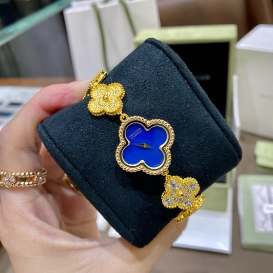 Van Cleef & Arpels watch with blue mother-of-pearl and diamond-set clover motif, featuring a blue dial.